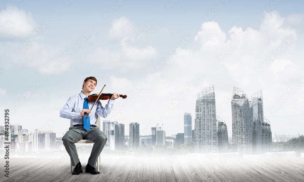young businessman playing violin young businessman playing violin