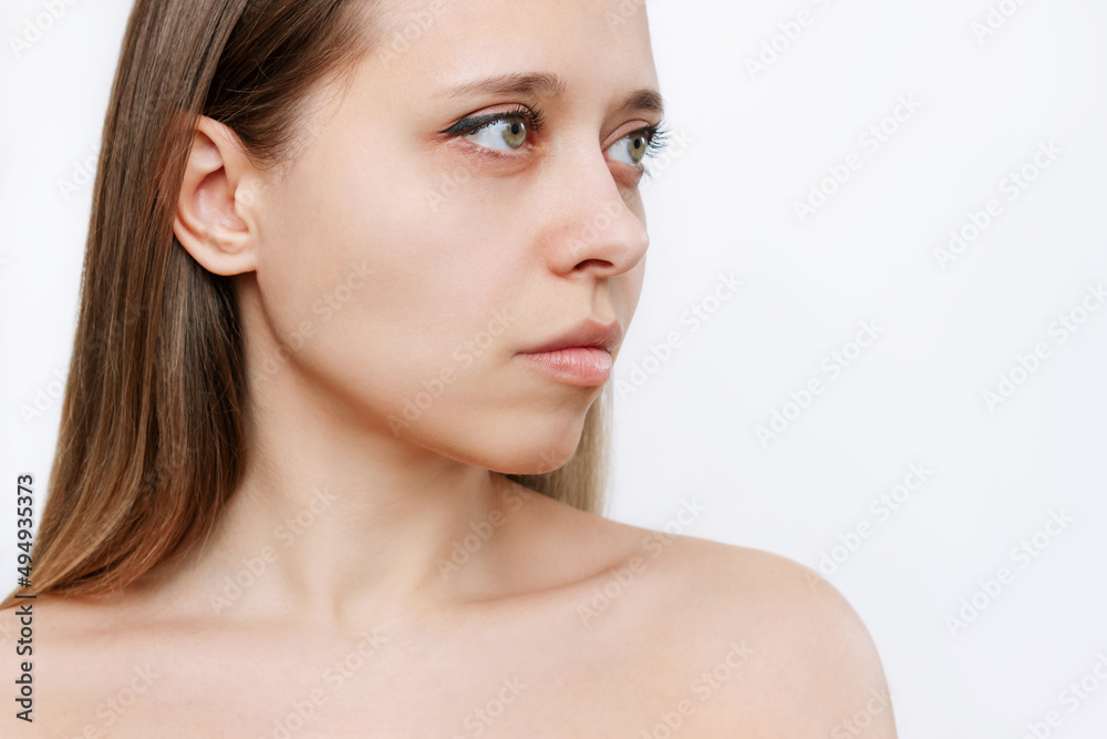 Portrait of a young attractive caucasian blonde woman with makeup isolated on a white background.Natural beauty and fashion. Skin care