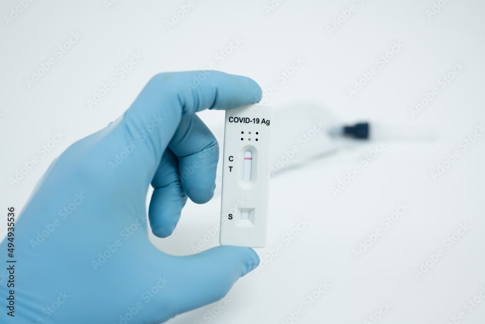 Medical technician wearing blue gloves taking a swab for corona virus sample from potentially infected.Covid-19 laboratory test. COVID-19 coronavirus pandemic protection concept Medical technician wearing blue gloves taking a swab for corona virus sample from potentially infected.Covid-19 laboratory test. COVID-19 coronavirus pandemic protection concept