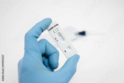 Medical technician wearing blue gloves taking a swab for corona virus sample from potentially infected.Covid-19 laboratory test.Antigen test kit for self collect nose swab .COVID-19 protection concept