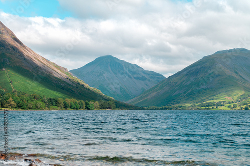 Wast Water or Wastwater is a lake located in Wasdale, a valley in the western part of the Lake District National Park, England, UK, beautiful summer day and blue cloudy sky