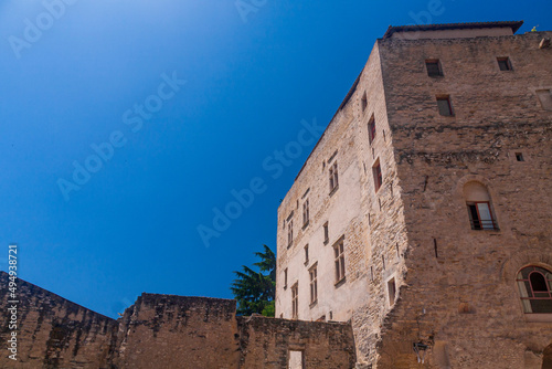 Ruin of a old castle in a village in Provence Avignon under a blue sky in a sunny day © Tak