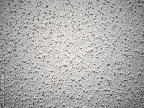Decorative plaster on a concrete wall painted with white paint. Construction and repair, wallpaper.