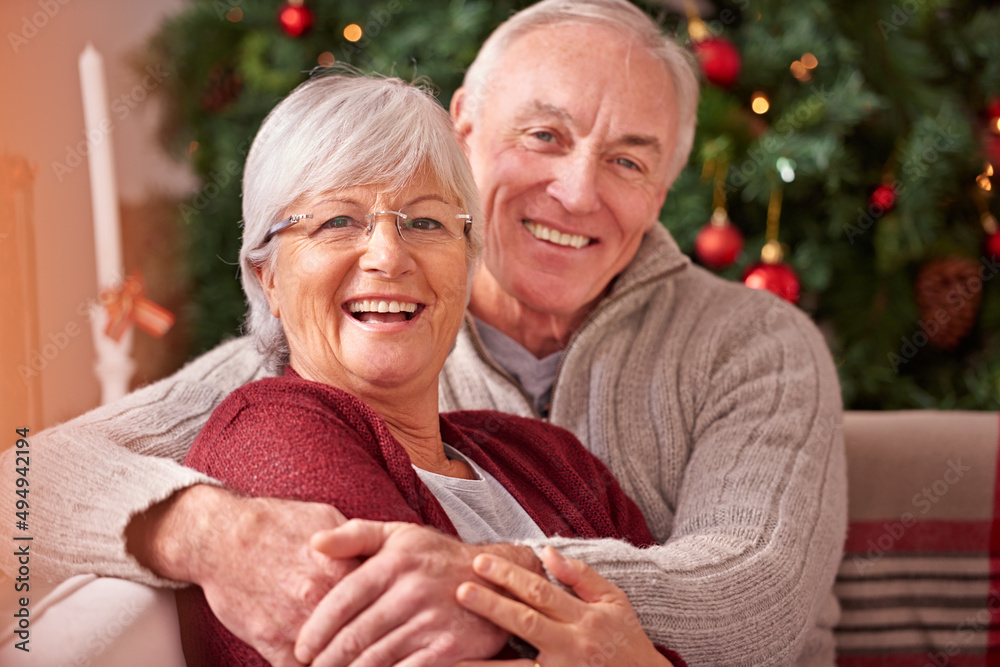 Its our favorite time of the year. Shot of a couple sharing christmas together at home. Its our favorite time of the year. Shot of a couple sharing christmas together at home.