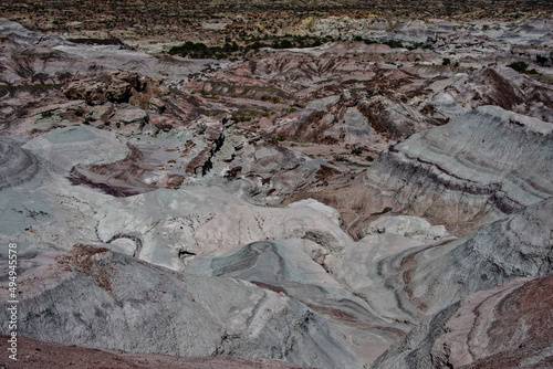 Aerial of rocky hills and mountains covered with shrubs in Ischigualasto provincial park, Argentina photo