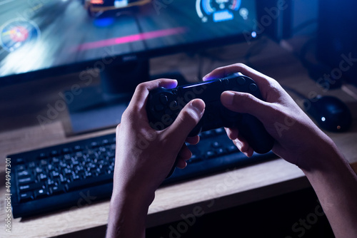 close up hand of young man playing video game holding controller