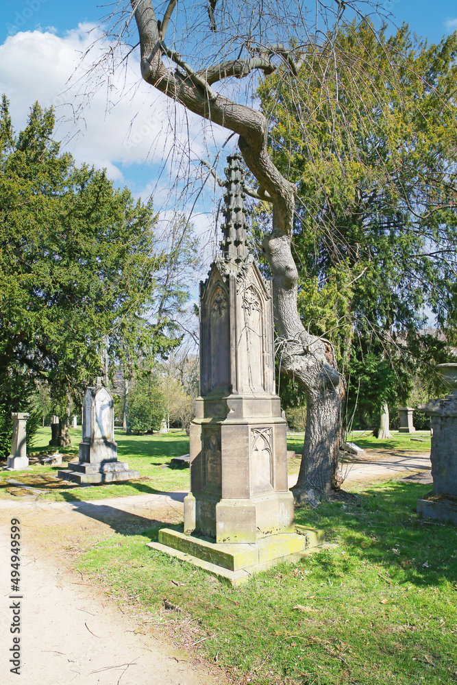 Düsseldorf (Golzheimer Friedhof), Germany - March 21. 2022: View on path through ancient city cemetery with listed monumental tombstones