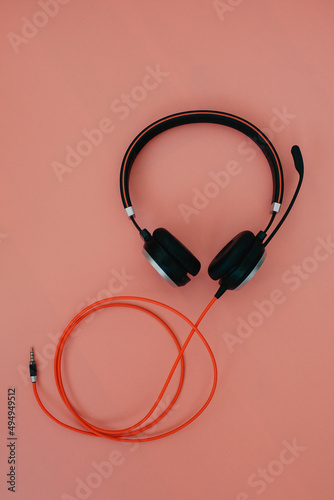 black headphone over pink color background,copy space.