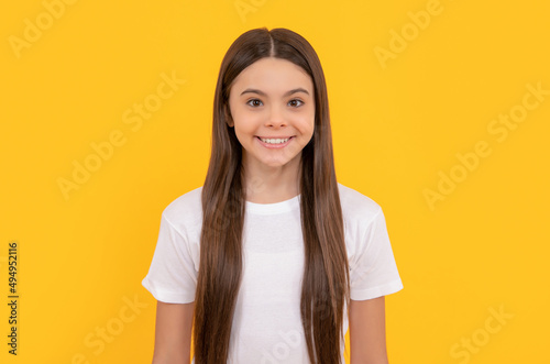 cheerful kid with long hair. beauty and fashion. female fashion model. pretty look of young girl