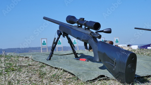 Fototapeta Naklejka Na Ścianę i Meble -  Modern powerful sniper rifle with telescopic view mounted on a bipod. Ammunition by rifle.