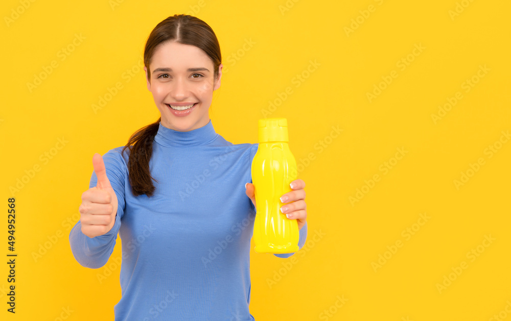 thumb up. be hydrated. smiling woman hold mineral water. feel thirsty. young girl thumb up. be hydrated. smiling woman hold mineral water. feel thirsty. young girl