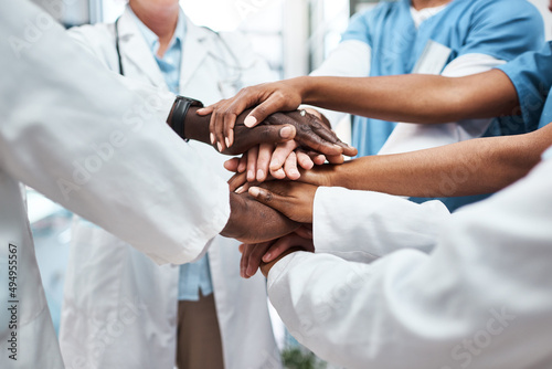 The value of collaboration is immeasurable. Closeup shot of a group of medical practitioners joining their hands together in a huddle.