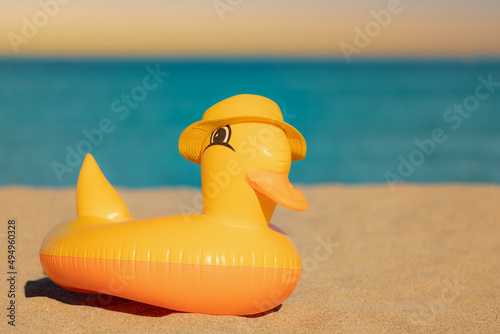 Yellow duck against blue sea and sky background