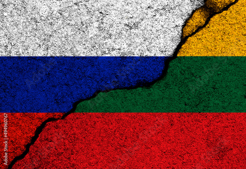 Lithuania and Russia flags painted on cracked concrete walls background photo
