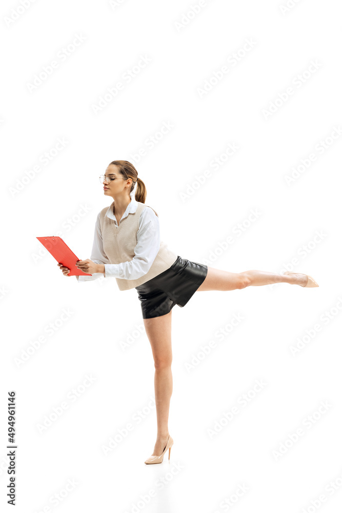 Portrait of young motivated woman, office worker reading business project on red folder, posing isolated over white studio background Portrait of young motivated woman, office worker reading business project on red folder, posing isolated over white studio background