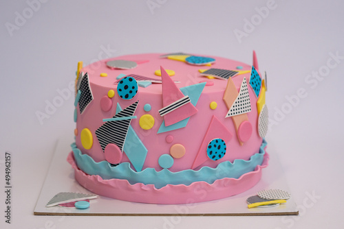 Photo of pink fondant cake with decorations