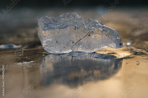 Closeup of a piece of ice on a wet ground