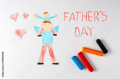 The father holds his son on his shoulders. Children's drawing with crayons. The inscription father's Day.