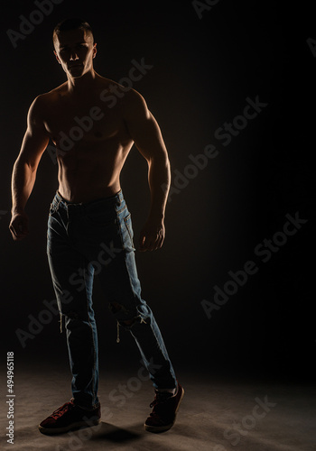 Posing topless in studio while standing, silhouette