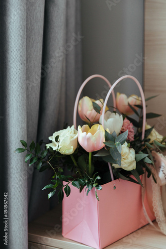 Bouquet of fresh flowers (roses, tulips, greens) in pink. The concept of a holiday, wedding, engagement, valentine's day, women's day, birthday or other events. 