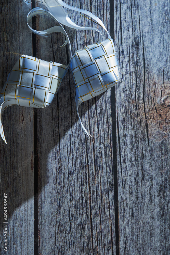 ribbon ketupat on the wood texture background