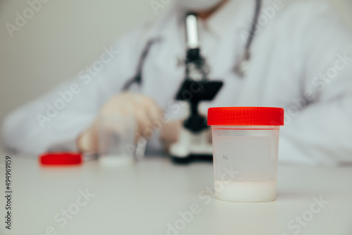 A plastic jar with sperm for semen analysis. Medical test in hospital