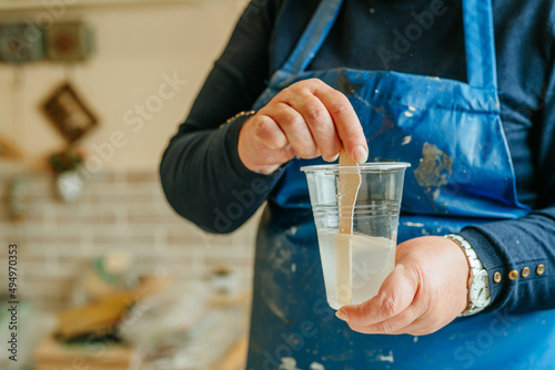 Woman prepairing ingredients for making clock in Resin art