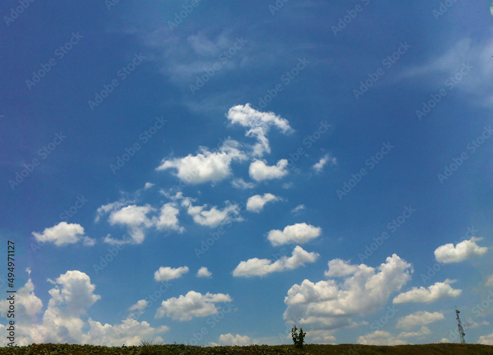 Blue sky and clouds background. Use for earth day concept. Sustainable development goals concept. Pollution air, Clean and fresh air concept. Global warming, Green energy. 