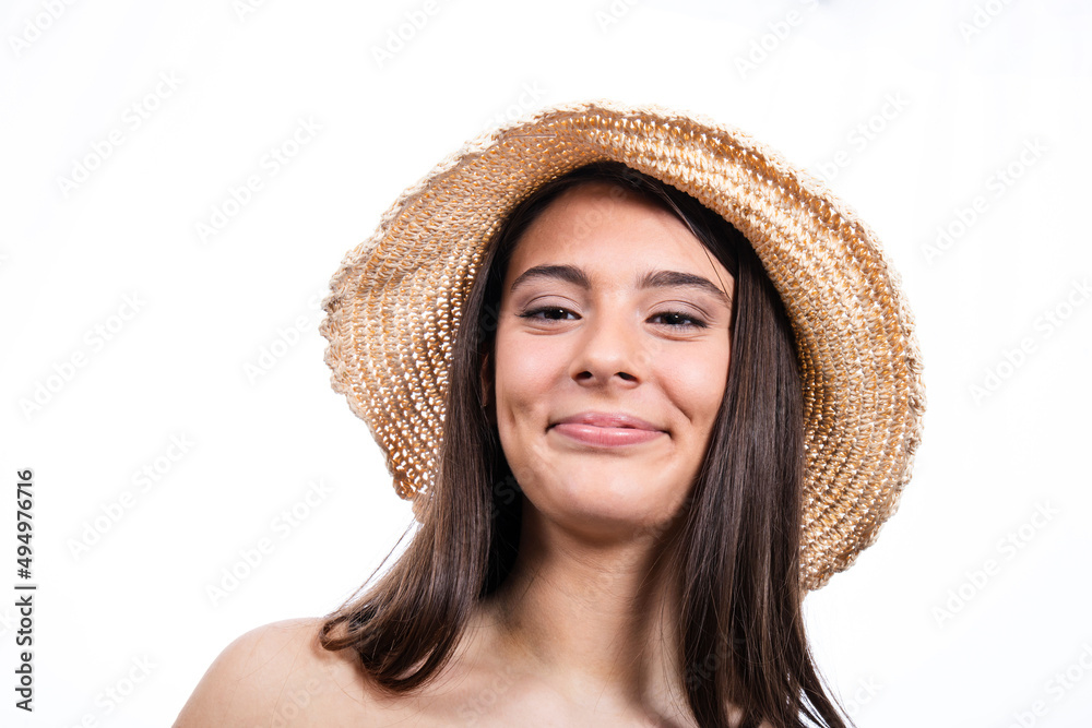 Portrait of beautiful smiling girl with long hair. The young woman is wearing a hat and looks into the camera. Portrait of beautiful smiling girl with long hair. The young woman is wearing a hat and looks into the camera.