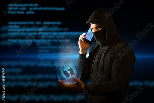 Scammer telephoning his victims while holding a broken padlock in his hand symbolizing breached security. Concept of vishing photo