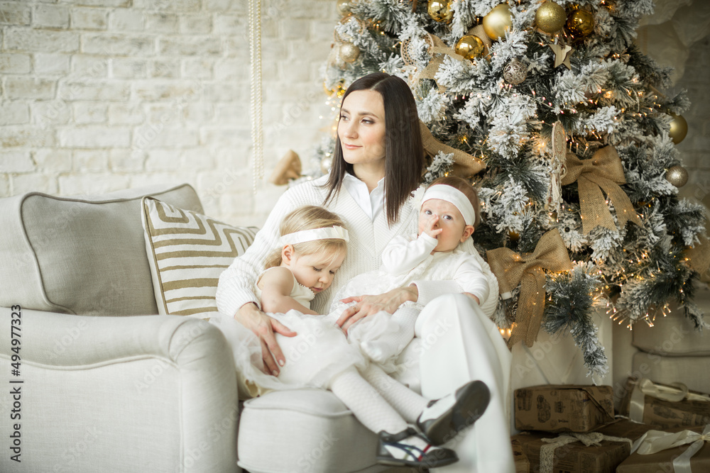 mother hugs her children, two happy sisters