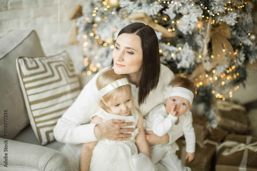 mother hugs her children, two happy sisters