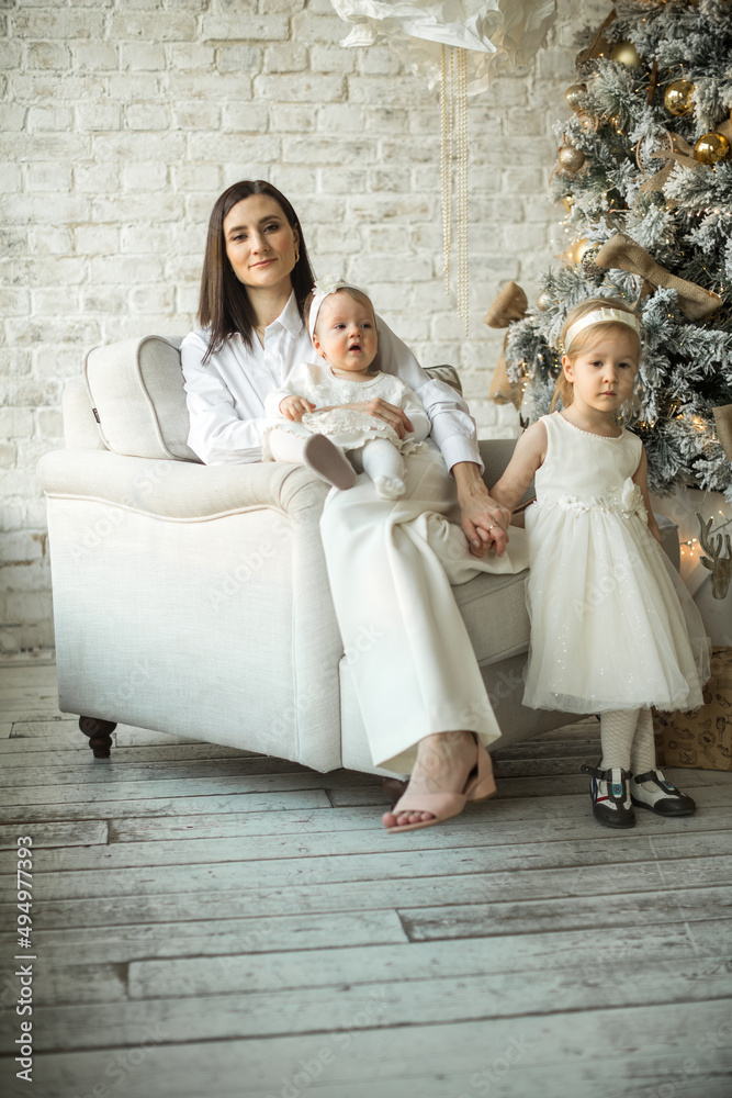 mother hugs her children, two happy sisters