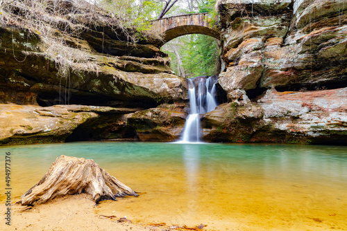 Waterfall with long exposure surrounded by rocks in Hocking Hills State Park, the US photo