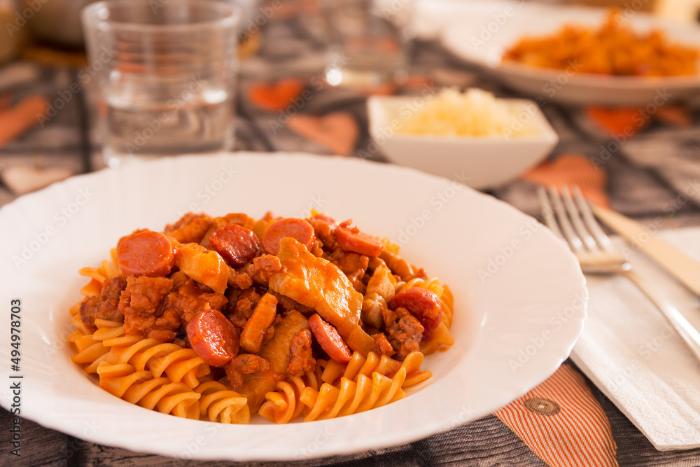 Fusili with meat, bacon, sausages and tomato sauce Fusili with meat, bacon, sausages and tomato sauce