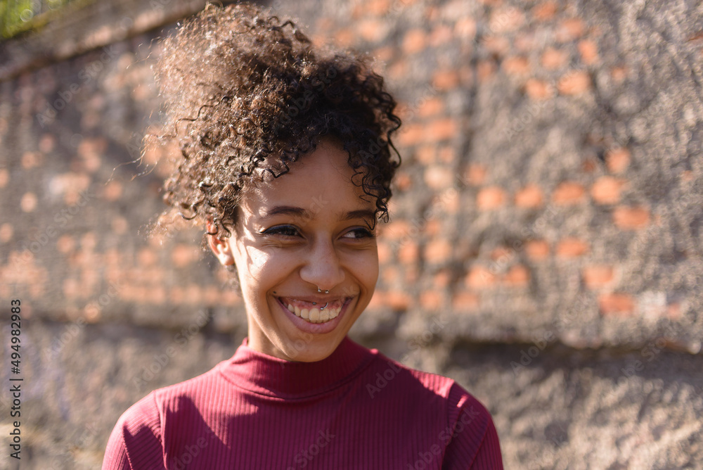 Black young woman portrait outdoors in urban landscape
