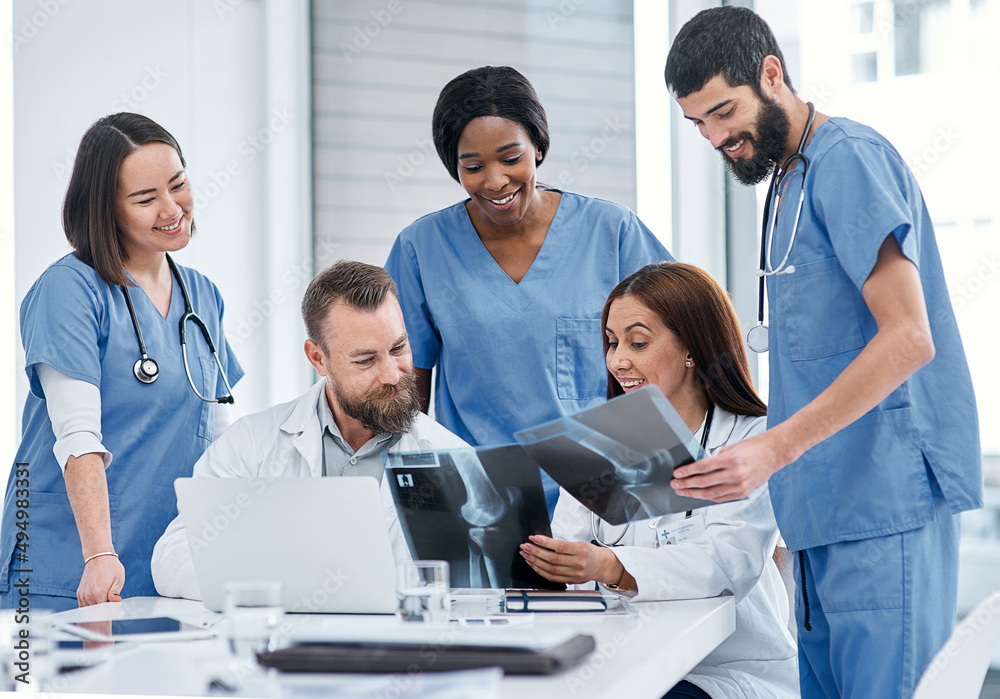 Coming together to do more thorough evaluations. Shot of a group of medical practitioners analysing x-rays in a hospital boardroom. Coming together to do more thorough evaluations. Shot of a group of medical practitioners analysing x-rays in a hospital boardroom.