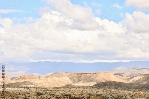 Beautiful view of the Desert Tabernas hills in Almeria, Spain against a cloudy sunny on the horizon