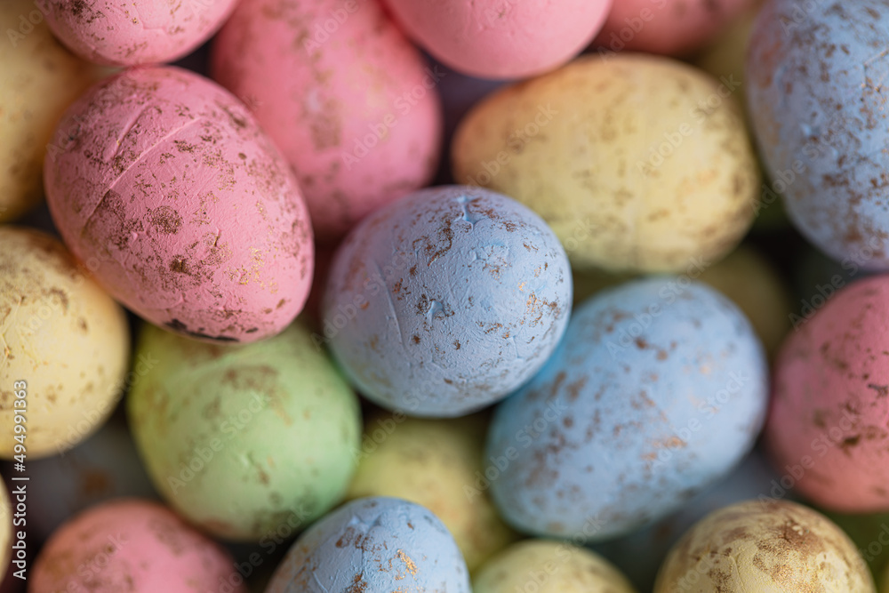 closeup of colorful small eggs background. closeup of colorful small eggs background.