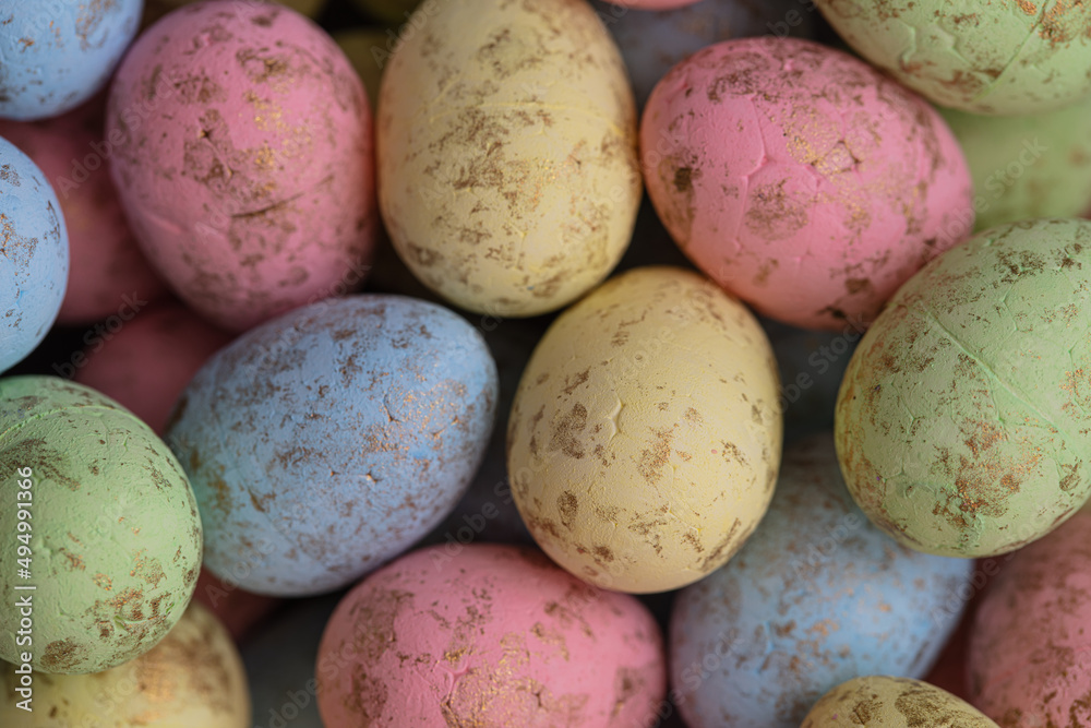 closeup of colorful small eggs background. closeup of colorful small eggs background.