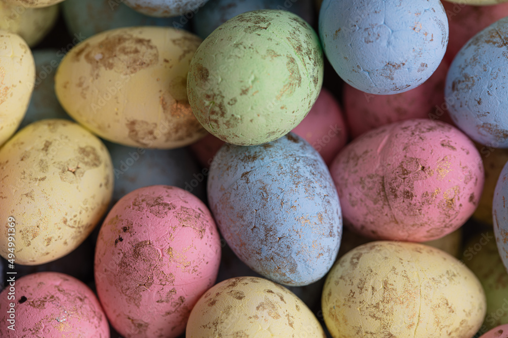 closeup of colorful small eggs background. closeup of colorful small eggs background.