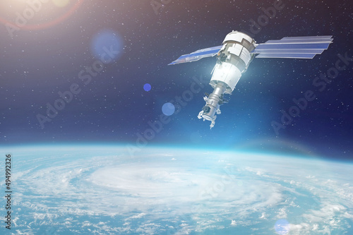 Research  probing  monitoring of tracking in a cyclonic vortex  a hurricane. Satellite above the Earth makes measurements of the weather parameters. Elements of this image furnished by NASA.