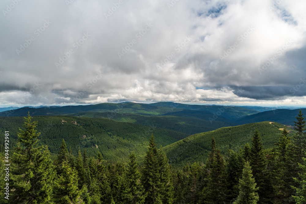 Jeseniky mountains in Czech republic with hills covered by forest with few rocks