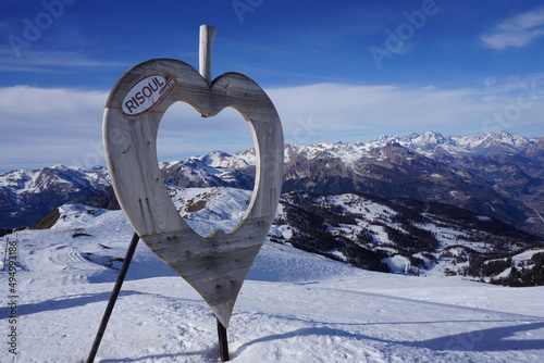 Risoul ski resort panorama and wood apple carving on top, Alps, France
