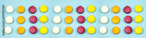 French Colorful Macaron Cookies isolated on blue background