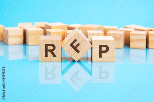 RFP text is made of wooden building blocks lying on the bright blue table, concept photo