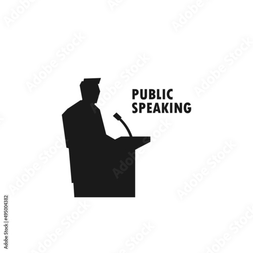 Man giving public speech on podium black vector silhouette illustration.