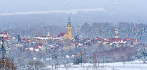 Panorama of the city of Bystrzyca Kłodzka, the view from the hill to the snow-covered city on a cloudy day.