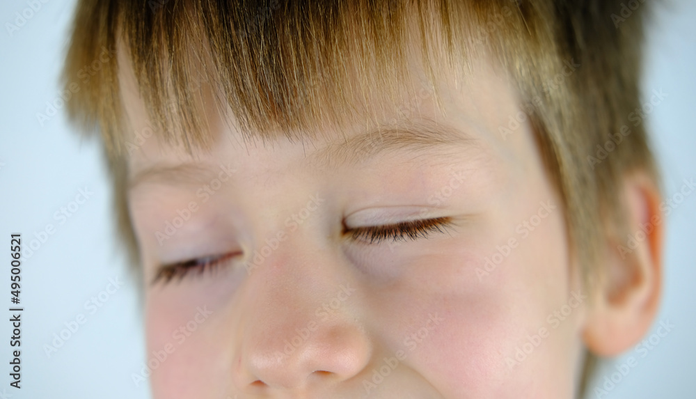 close-up of mischievous face of embarrassed child, happy boy 8-10 years old screwed up his eyes, conceived a funny prank, childhood, problems of growing up children close-up of mischievous face of embarrassed child, happy boy 8-10 years old screwed up his eyes, conceived a funny prank, childhood, problems of growing up children
