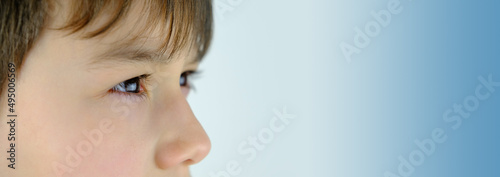 close-up of part of the child's face, boy 10-12 years old, sad, anxious face of teenager, difficult childhood, victim of domestic violence, psychological difficulties of loneliness, outsider photo